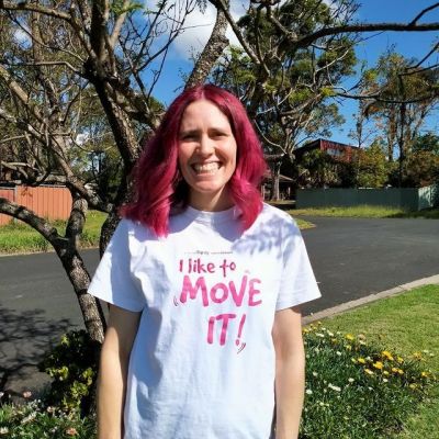 Jenni has won the Spirit of Move award for week 4, her hair is dyed pink and she smiles for the camera while wearing her move4dignity tshirt