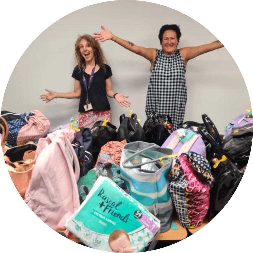 Two Shero volunteers with bags from It's in the Bag