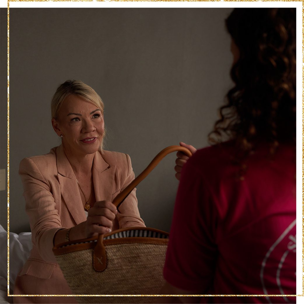 A woman receives a donated bag of life's essentials A woman receives a donated bag of life's essentials