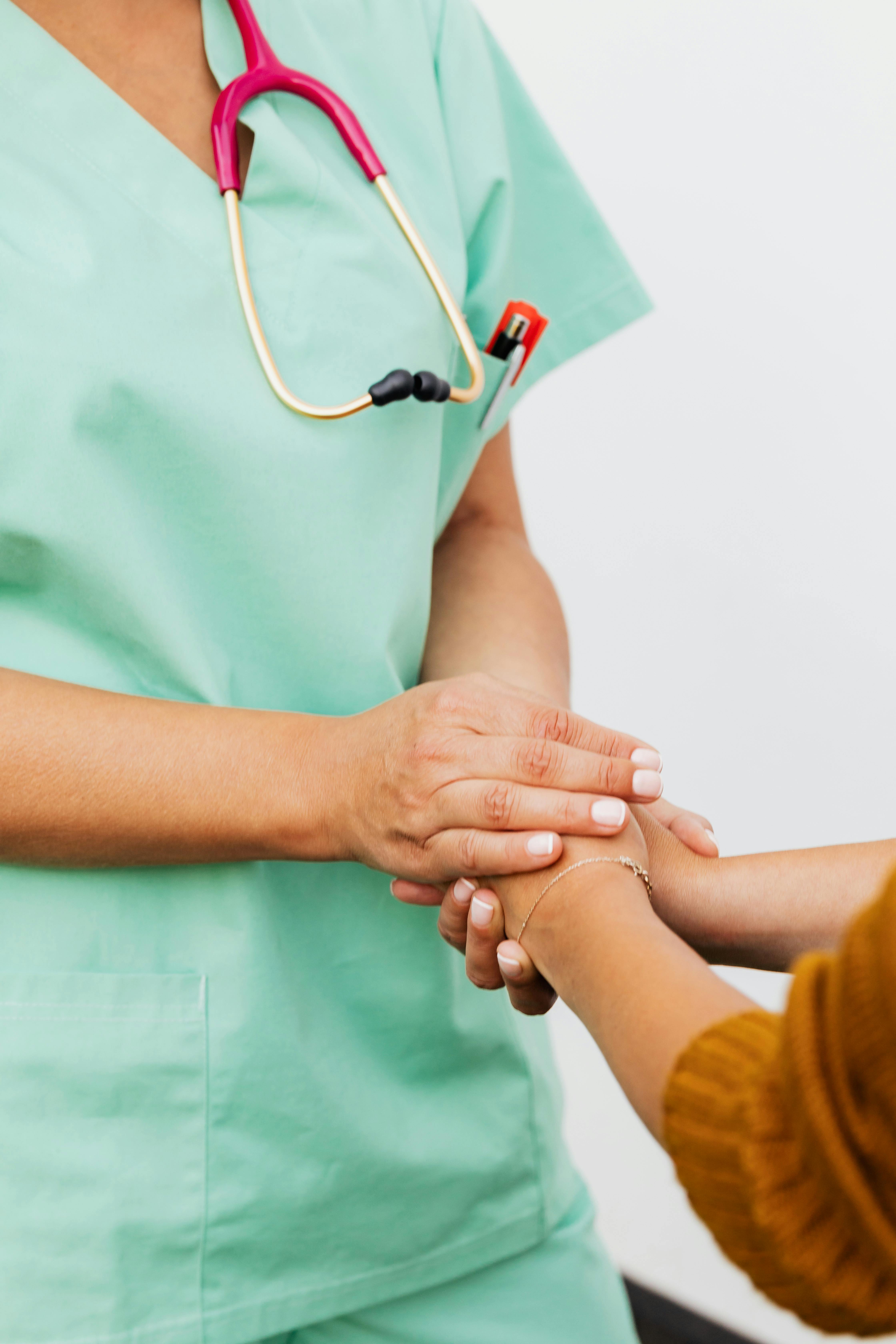 A nurse comforts her patient