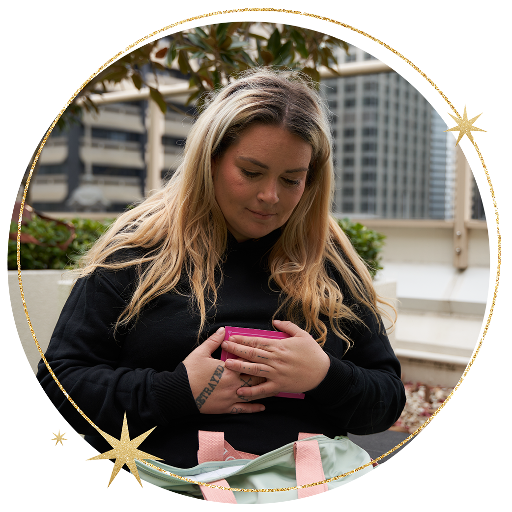 A woman receives a donated bag of life's essentials A woman receives a donated bag of life's essentials